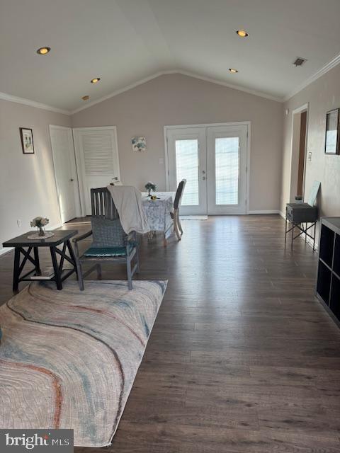 living room with visible vents, dark wood-type flooring, ornamental molding, french doors, and lofted ceiling