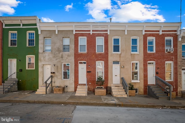 view of property featuring brick siding and entry steps