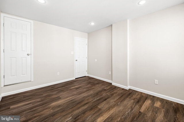 unfurnished bedroom featuring recessed lighting, baseboards, and dark wood-style flooring