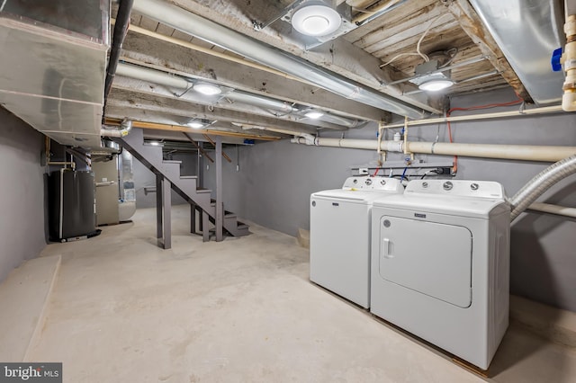 laundry area featuring laundry area, heating unit, independent washer and dryer, and water heater