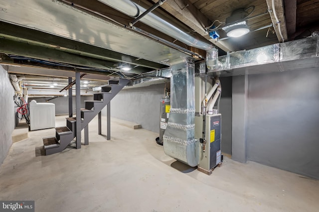 unfinished basement with heating unit, washer / clothes dryer, water heater, and stairway