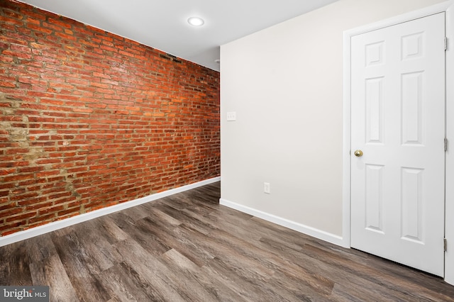 445 Pitman Pl, Baltimore, MD 21202 - unfurnished room with brick wall, baseboards, and wood finished floors