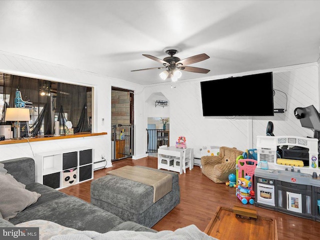 living area featuring wood finished floors and a ceiling fan