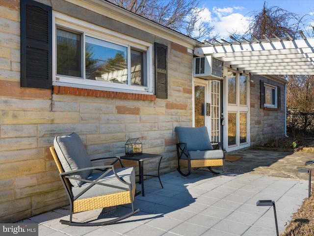 view of patio featuring a wall mounted air conditioner, french doors, and a pergola