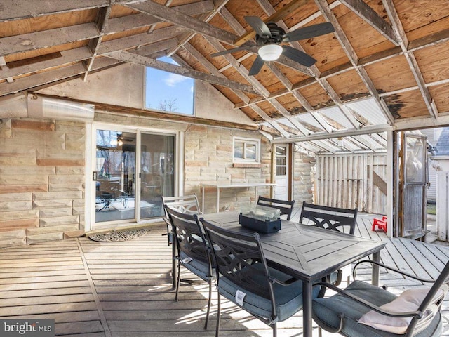 wooden terrace featuring outdoor dining space and a ceiling fan