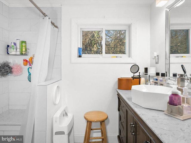 bathroom featuring baseboards, a shower with curtain, and vanity