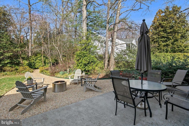 view of patio with outdoor dining space and an outdoor fire pit