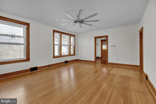 unfurnished room with visible vents, baseboards, light wood-style floors, and a ceiling fan