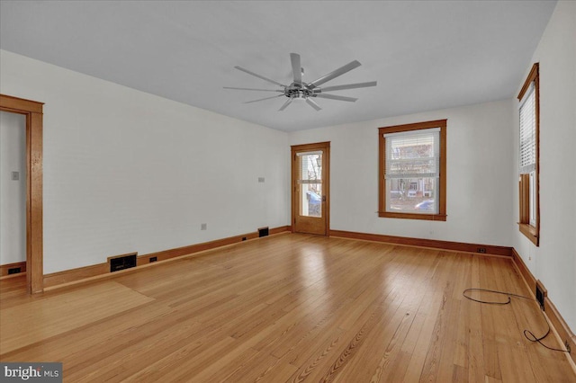 unfurnished living room featuring visible vents, baseboards, light wood-style flooring, and a ceiling fan