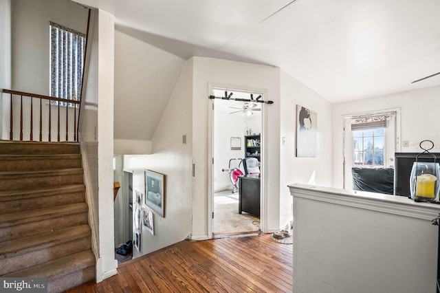 corridor with hardwood / wood-style floors and stairs