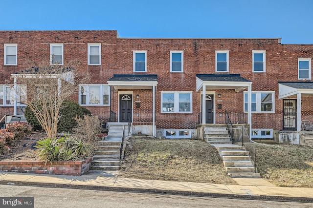 townhome / multi-family property with brick siding