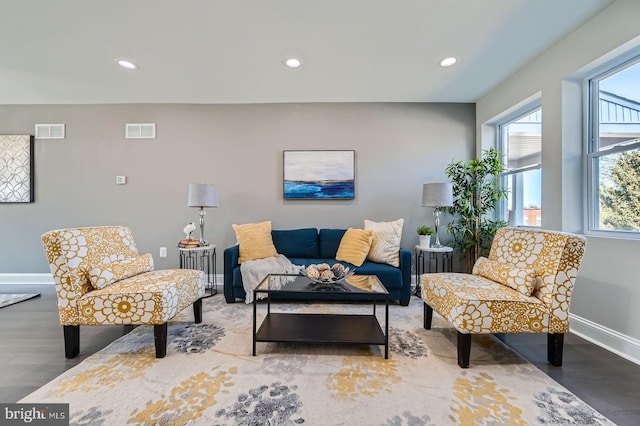 living area featuring recessed lighting, visible vents, baseboards, and wood finished floors