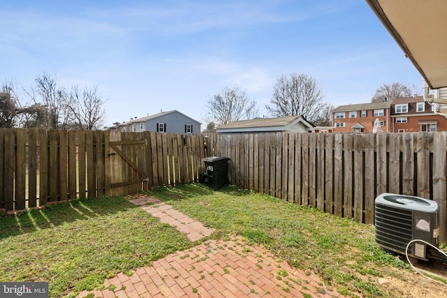 view of yard featuring a patio area, central AC unit, and a fenced backyard