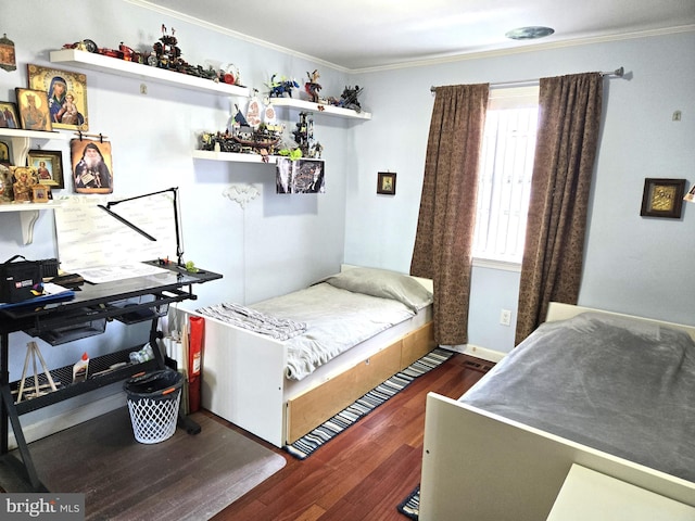 bedroom with baseboards, wood finished floors, and crown molding