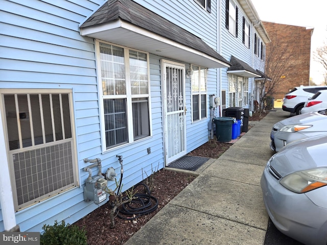 view of exterior entry with central air condition unit