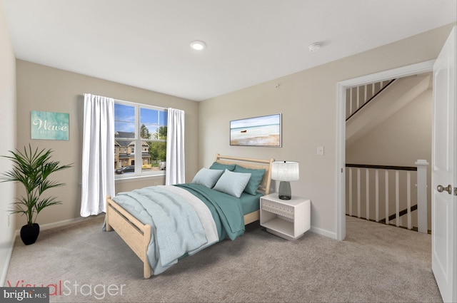 carpeted bedroom featuring baseboards