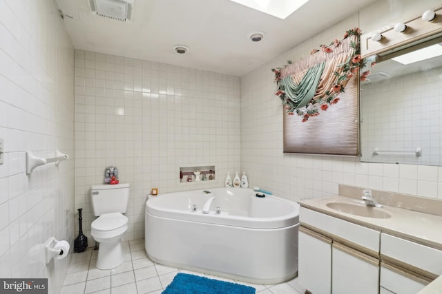 full bathroom featuring tile patterned floors, visible vents, tile walls, a bath, and vanity