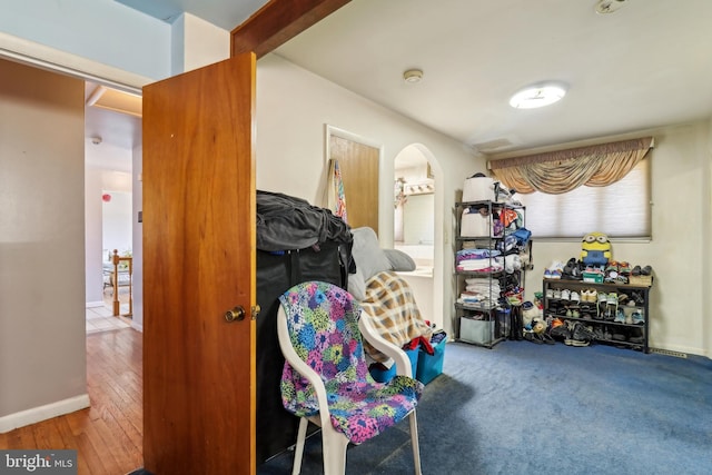 interior space featuring baseboards and arched walkways