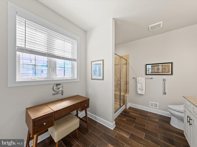 bathroom featuring a shower stall, baseboards, visible vents, and wood tiled floor