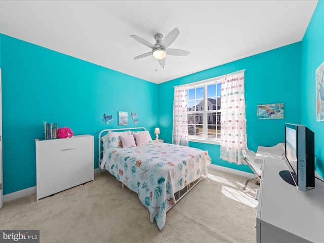 carpeted bedroom with baseboards and ceiling fan