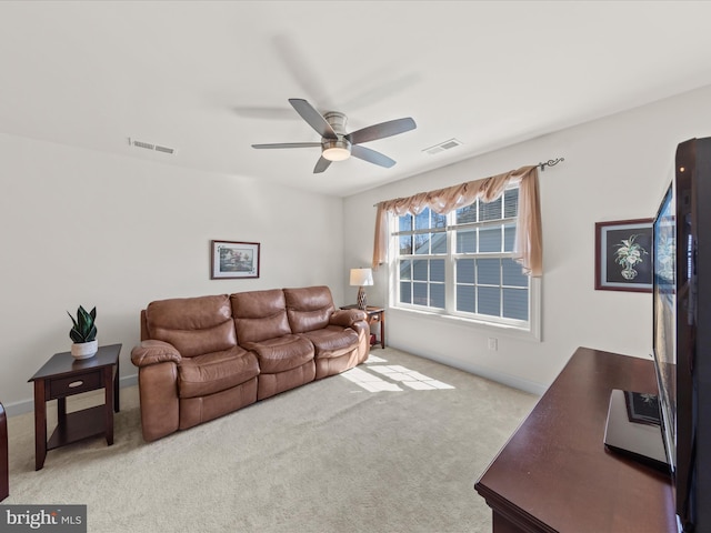 carpeted living room with a ceiling fan, visible vents, and baseboards