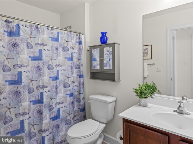 bathroom featuring toilet and vanity