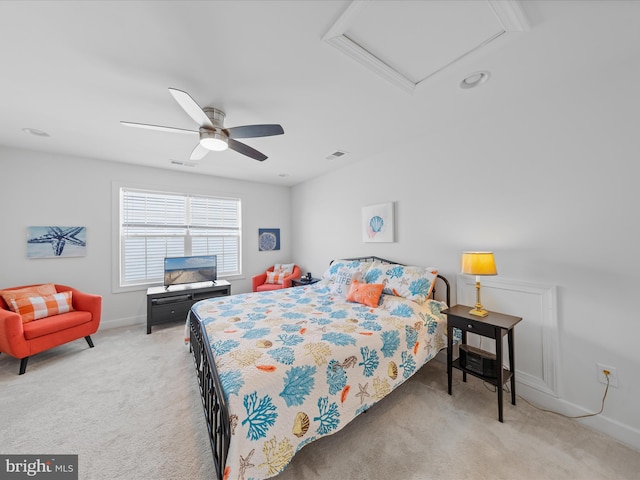 bedroom featuring visible vents, baseboards, ceiling fan, attic access, and carpet flooring