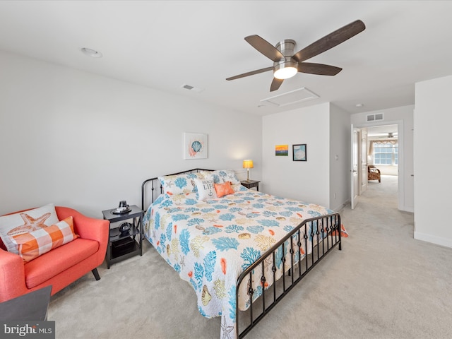 bedroom featuring visible vents, carpet floors, attic access, and a ceiling fan