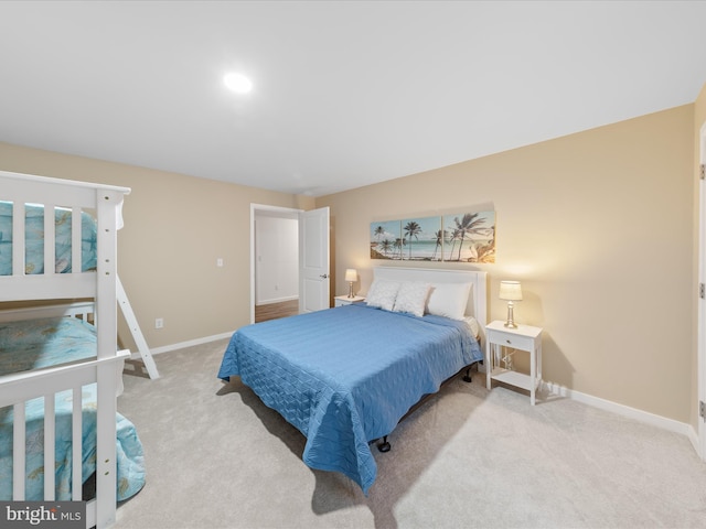 bedroom with baseboards and carpet floors