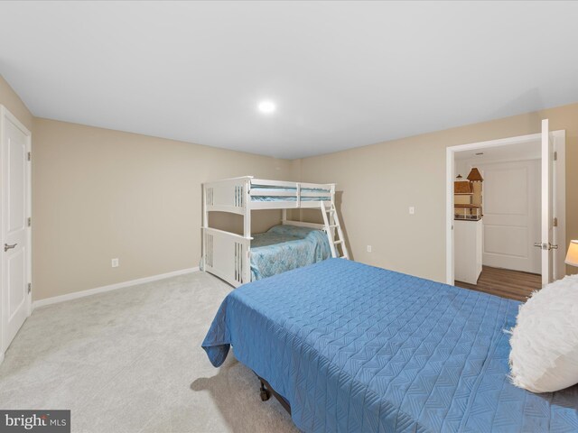 carpeted bedroom featuring baseboards