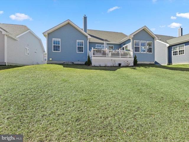 back of house featuring a yard and a wooden deck