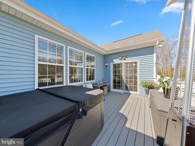 wooden deck with a hot tub