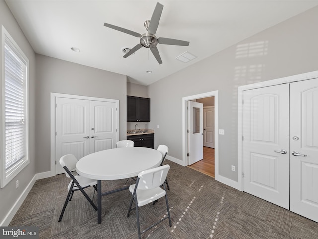 dining room featuring a wealth of natural light, visible vents, baseboards, and a ceiling fan