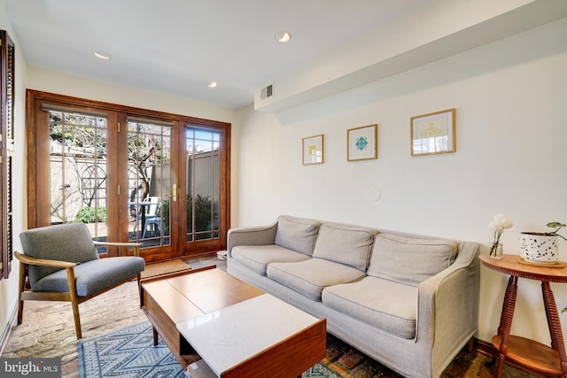 living area featuring visible vents and recessed lighting