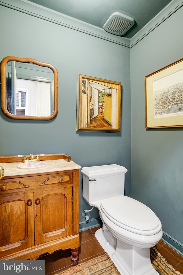 bathroom with visible vents, baseboards, toilet, tile patterned floors, and vanity