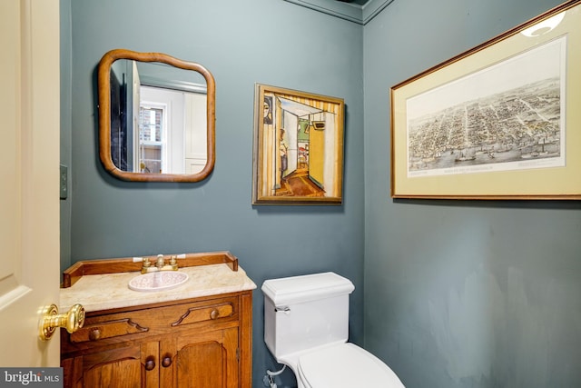 bathroom featuring toilet and vanity