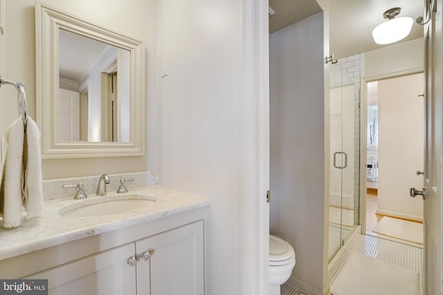 bathroom featuring toilet, a stall shower, vanity, and tile patterned flooring