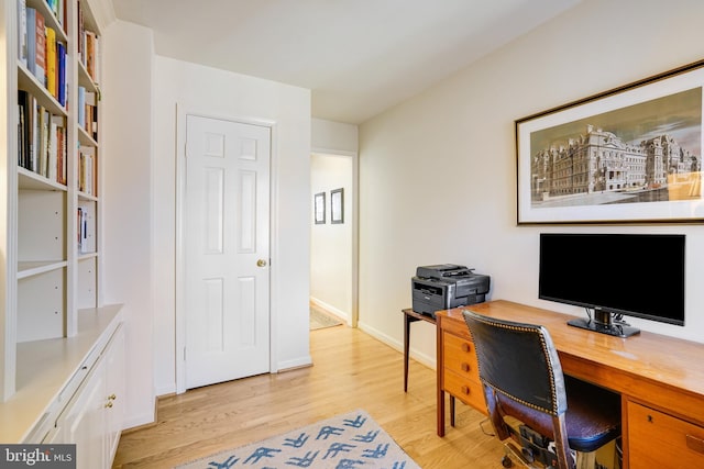 office with baseboards and light wood-style floors