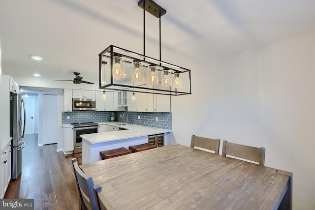 dining area with recessed lighting, dark wood finished floors, and a ceiling fan