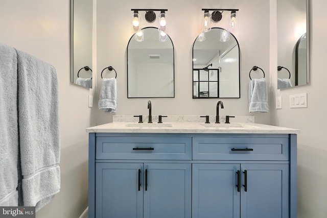 bathroom featuring a sink and double vanity