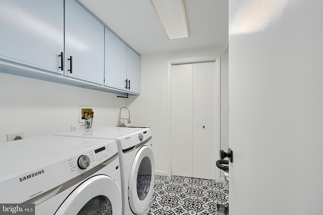 laundry area with light tile patterned floors, cabinet space, separate washer and dryer, and a sink