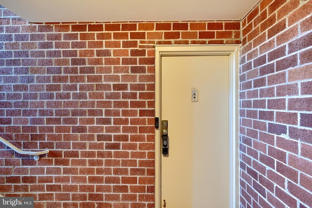 entrance to property featuring brick siding