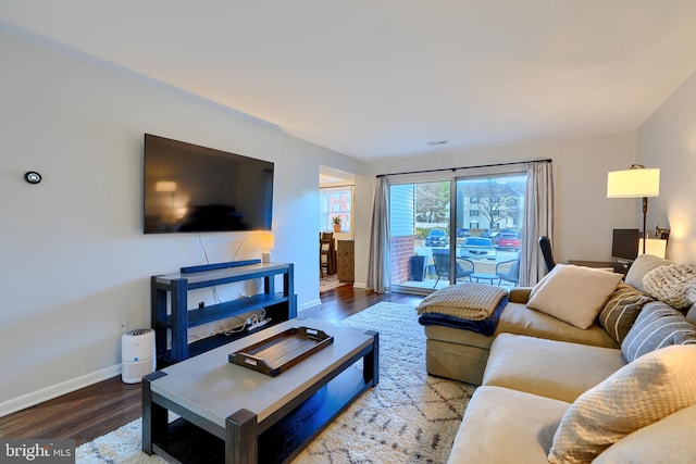 living room with wood finished floors and baseboards