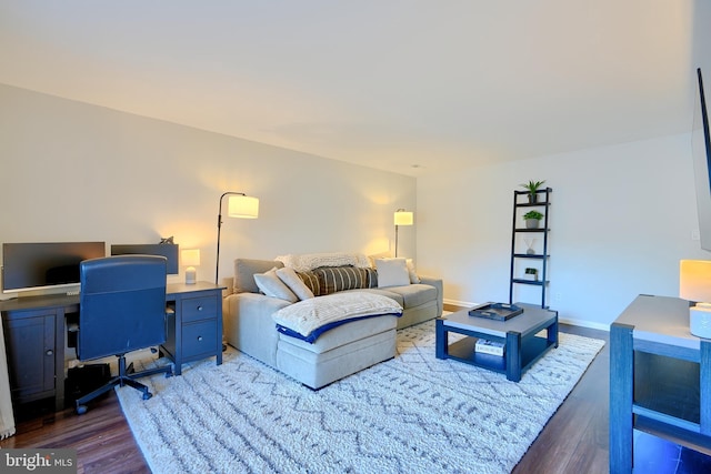 living area featuring wood finished floors and baseboards