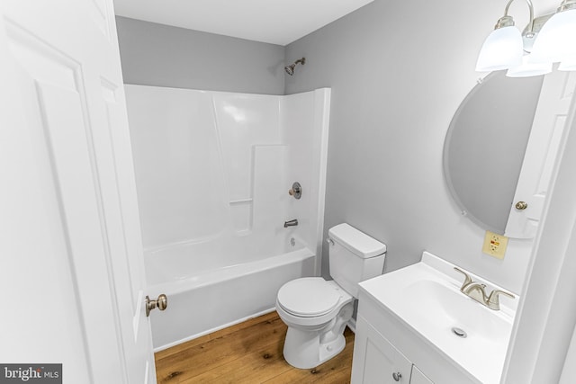 full bath with vanity, shower / tub combination, toilet, and wood finished floors