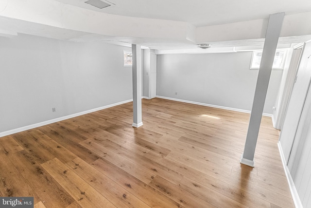 below grade area with light wood-type flooring and baseboards