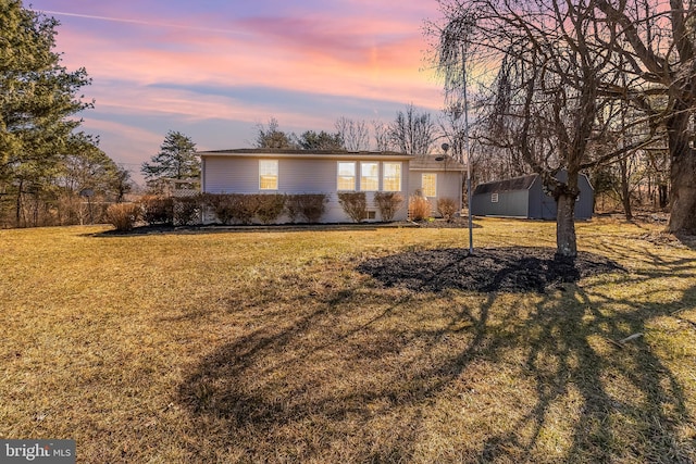 mid-century modern home with a storage unit, an outbuilding, and a front yard