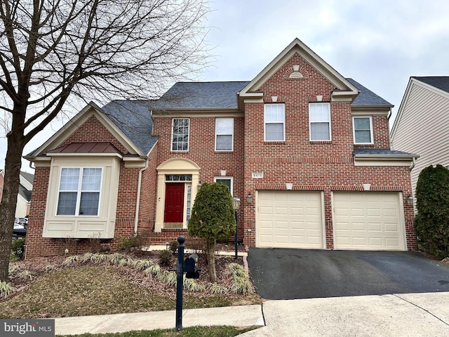 view of front of property featuring brick siding, driveway, and a garage