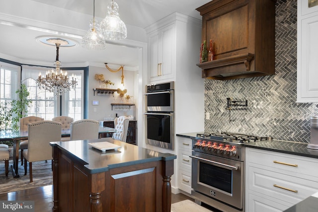 kitchen featuring white cabinetry, dark countertops, and stainless steel appliances