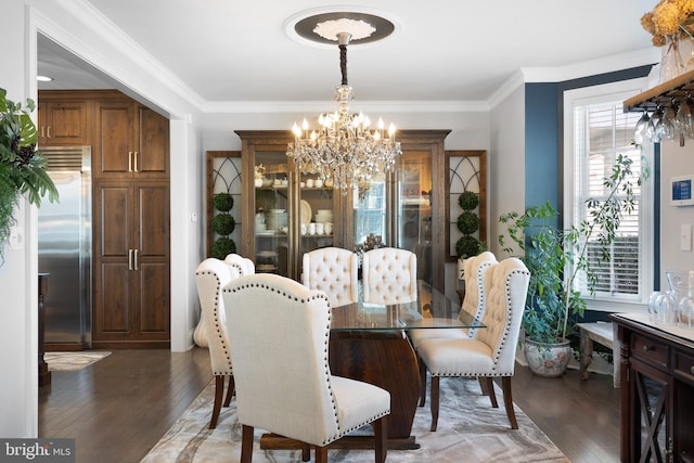 dining area with a chandelier, light wood-style floors, and ornamental molding